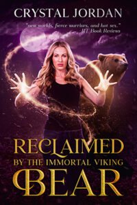Reclaimed by the Immortal Viking Bear cover - a blonde woman in black jeans and tank top holds her hands out with magic swirling between them, in the background is a brown bear and a full moon